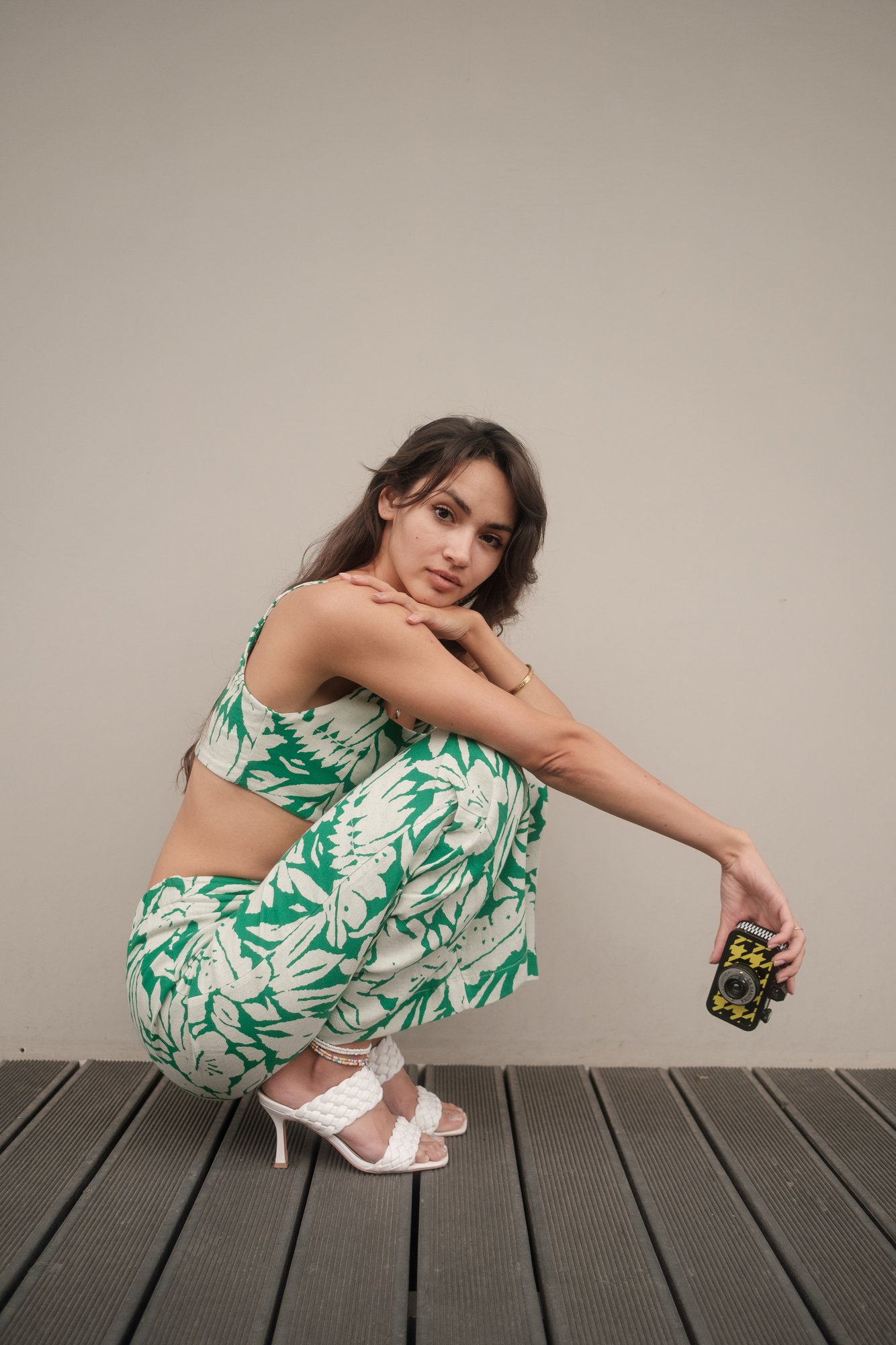 Woman Sitting while Holding  a Camera 